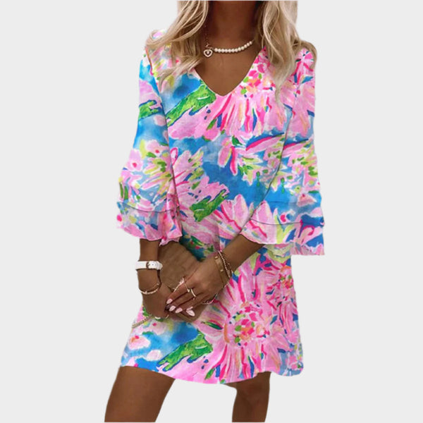 Elegante miniabito rosa con maniche curve